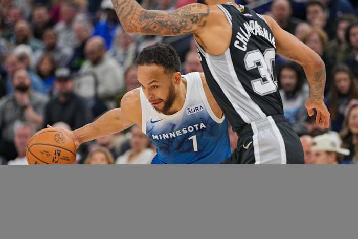 Minnesota Timberwolves forward Kyle Anderson (1) dribbles against the San Antonio Spurs forward Julian Champagnie (30) in the first quarter at Target Center in Minneapolis on Feb. 27, 2024.